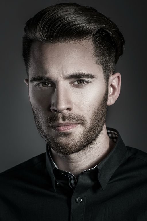 Studio portrait of a man against a dark background