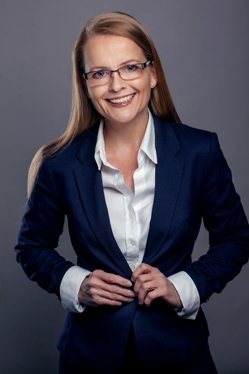 Professional portrait of a woman in a navy jacket