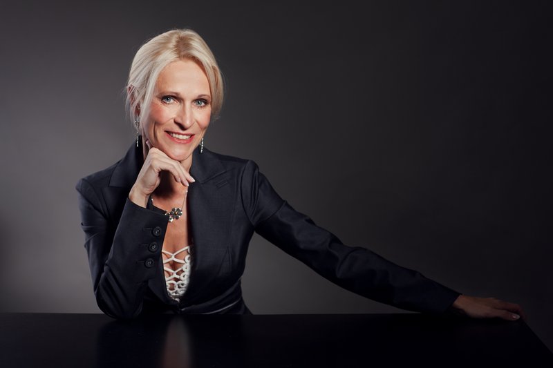 Professional portrait of a woman in a black jacket
