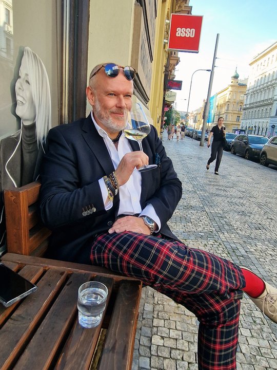 Petr Lukeš wearing a navy jacket and checked trousers